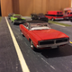 A couple of mopars driving down the road.